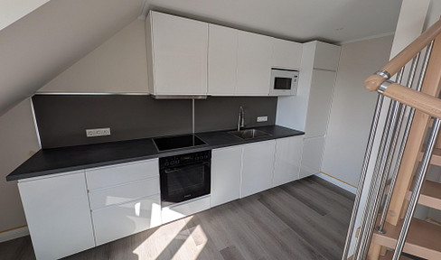4-room penthouse maisonette, built to KfW70EE energy efficiency standards, in a prime location in Rüdesheim, with elevator access, kitchen, and balcony.