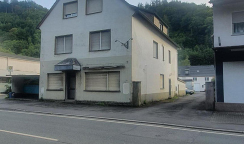 Multi-family house with commercial unit in a prime location. Features include a terrace, garage, outdoor space, etc., and is located on a main street.