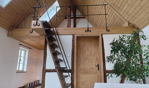 A home with character – timber framing, clay, and evening sunlight.