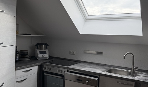 Bright, sun-filled attic apartment with a balcony and elevator access.