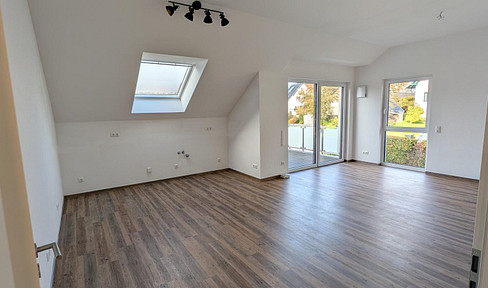 Bright, sun-filled attic apartment with a balcony and elevator access.