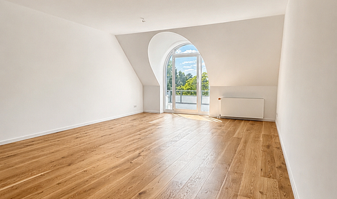 Stylish renovated attic apartment with arched dormer windows and a balcony in Kirchrode.