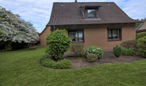Well-maintained single-family house with outbuildings and a large plot of land.