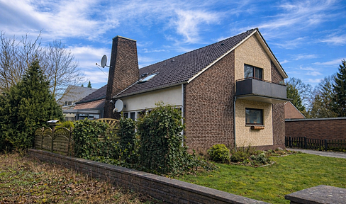 Solid investment opportunity: Rented two-family house with garage and parking spaces.