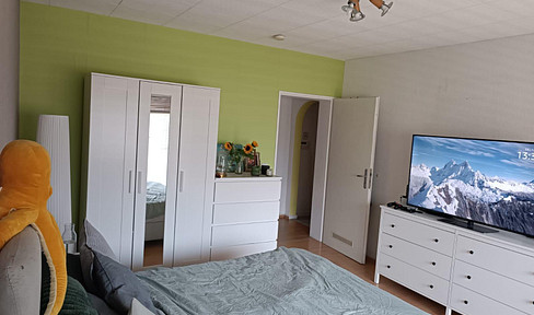 Brühl city center: 3-room apartment with fitted kitchen, sofa, bed, balcony, and garden.