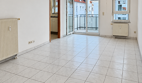 Bright 2-room apartment with fitted kitchen, balcony, and underground parking space.