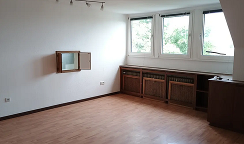 Bright attic apartment with a large west-facing balcony.