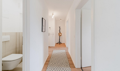 Spacious, modernly renovated 4-room apartment with a south-facing balcony and a private garage.