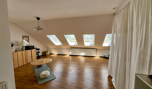 Attic apartment with a loft-like feel and a balcony.