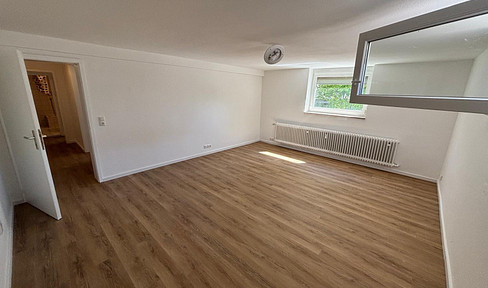2-room basement apartment with a terrace, new fitted kitchen, and parking space.