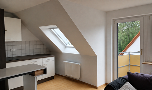 Attractive attic apartment with a balcony, parking space, and additional attic storage.