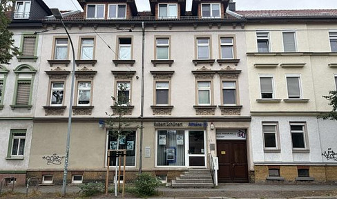Multi-family house with a large rear building and two garages.