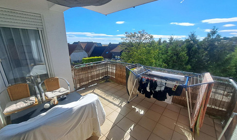 Spacious living with a balcony, bathtub, extended-length garage, and parking space.