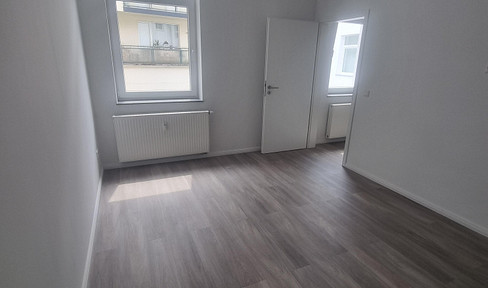 Two-room apartment including a fitted kitchen and a washing machine.
