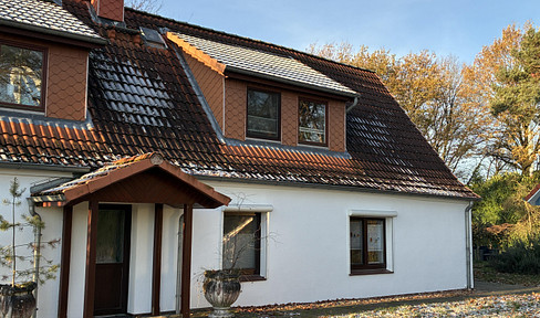 Semi-detached house in a green setting.