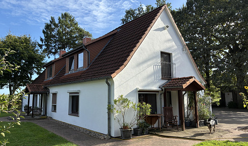 Semi-detached house in a green setting.