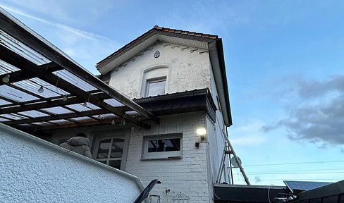 Semi-detached house in need of renovation, with an extension.