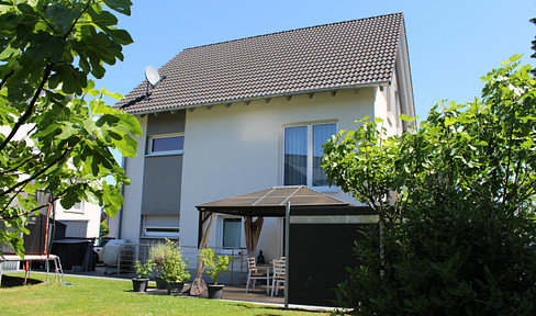 Energy-efficient multi-generational/two-family home with a garden, located in a quiet area on the outskirts of town.