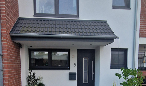 Well-maintained terraced house with a garden, garage, and converted attic.