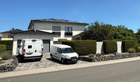 Architect-designed house with a Mediterranean flair, a double garage, and a large garden.