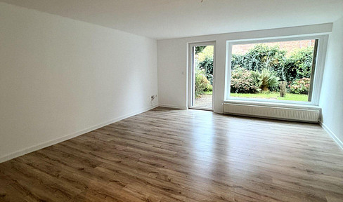 Renovated 2-room apartment on the ground floor with a south-facing terrace, garden access, and parking space.
