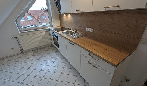 Attractive 2-room attic apartment with fitted kitchen and balcony in Bramsche.