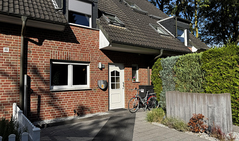 Well-maintained terraced house with a west-facing garden, garage, and solar panels.