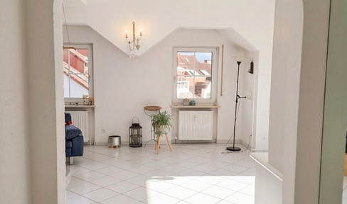 Bright and spacious architect-designed house: Stylish attic apartment with open fireplace, balcony, and underground parking.
