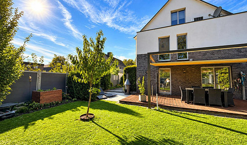 Modern single-family home with a stylish living environment, a beautiful garden, and a sauna.