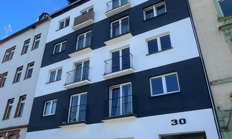 Energy-efficiently renovated multi-family building complex with 16 residential units.