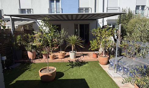 Modern family home with solar panel system, battery storage, wallbox charger, and rooftop terrace.