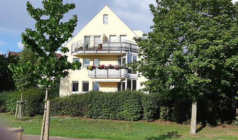 2-room apartment on a high floor with a balcony, fitted kitchen, and 2 parking spaces, offering a view of the greenery.